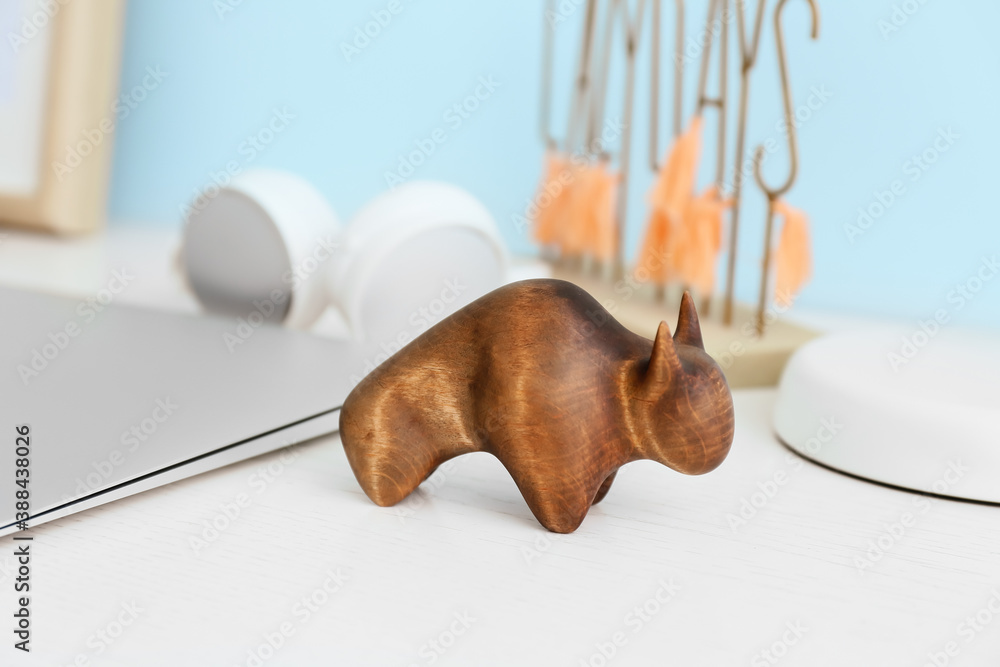 Figurine of bull as symbol of year 2021 on table in room