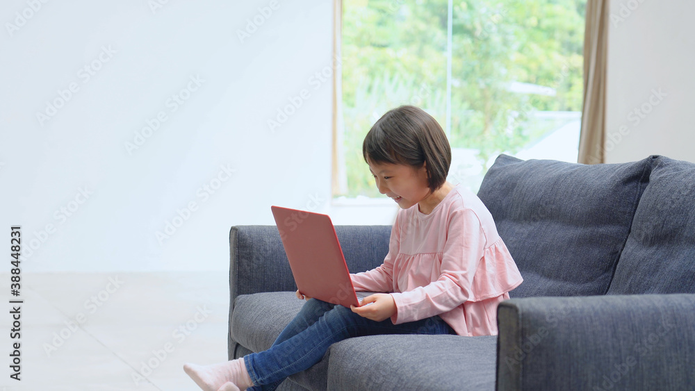 ソファーでパソコンを使う女の子
