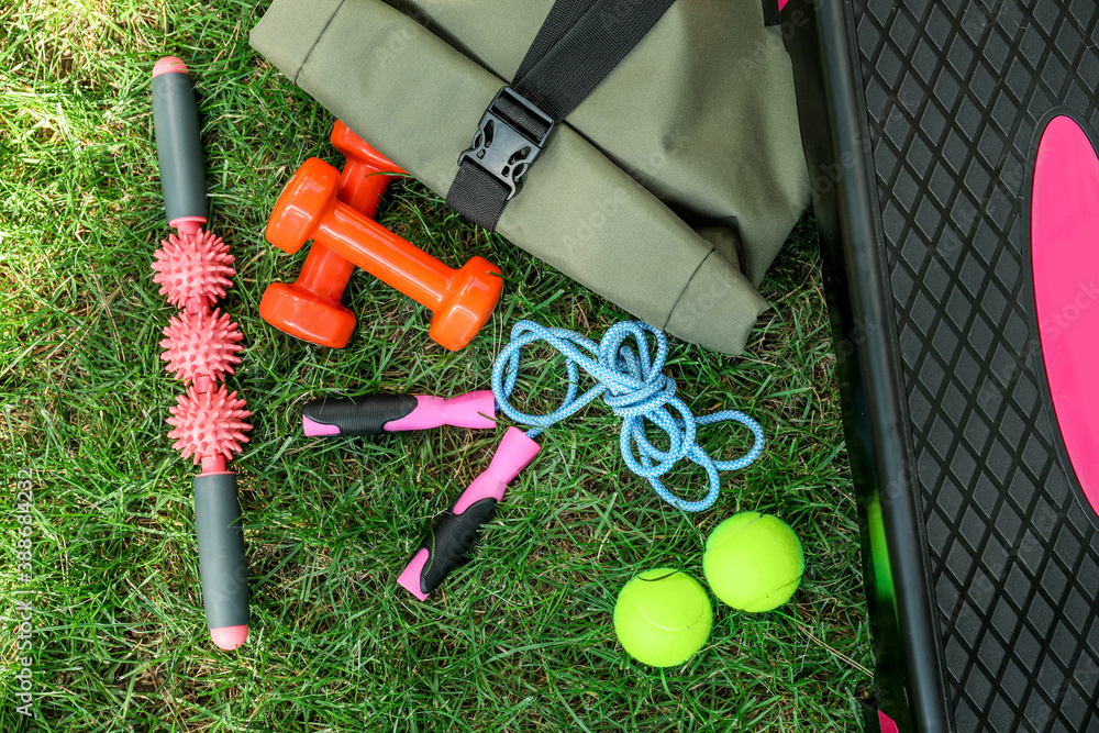 Set of sport equipment on green grass