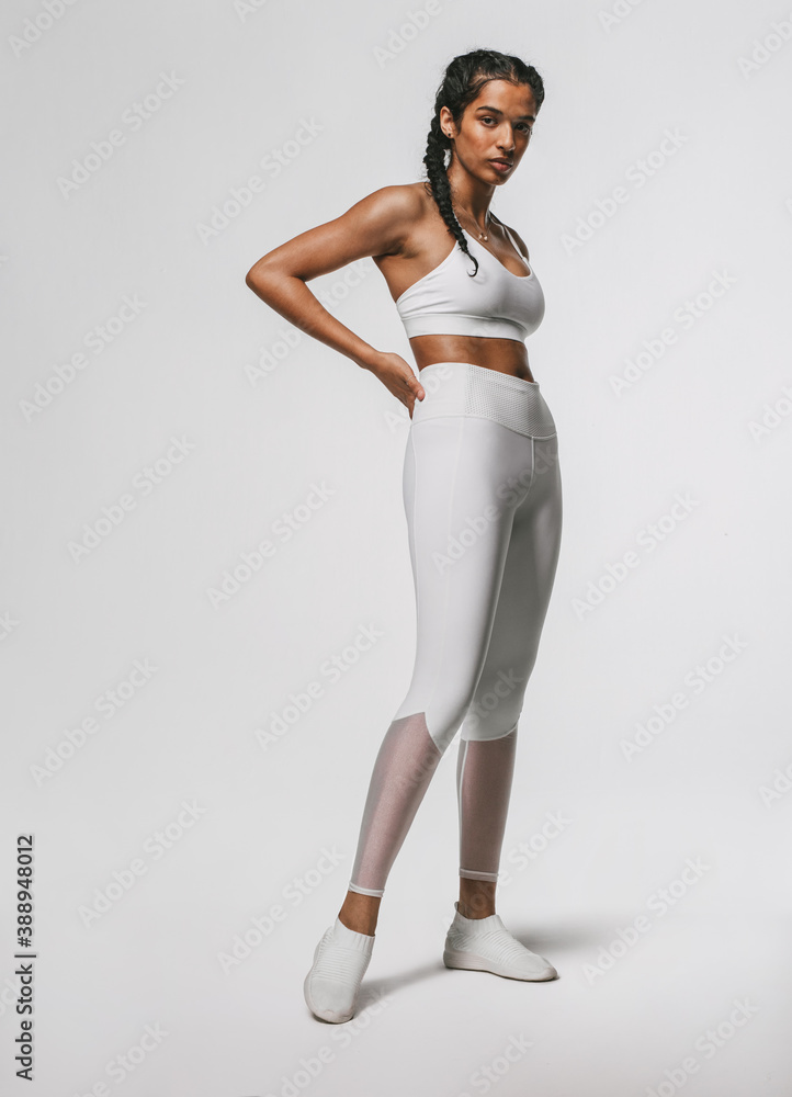 Portrait of fitness woman standing against white background