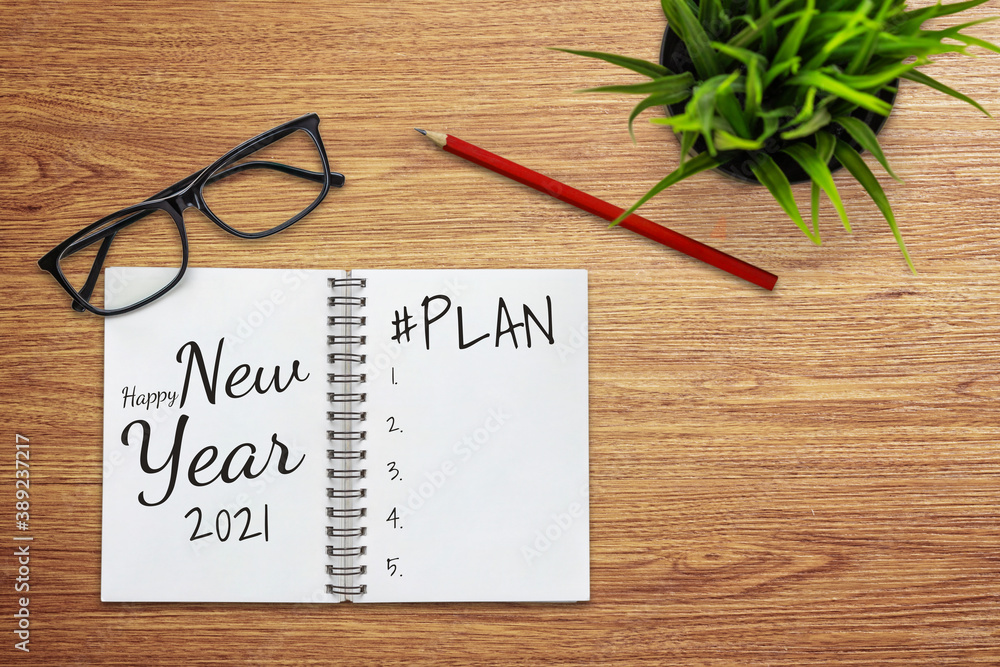 2021 Happy New Year Resolution Goal List - Business office desk with notebook written in handwriting