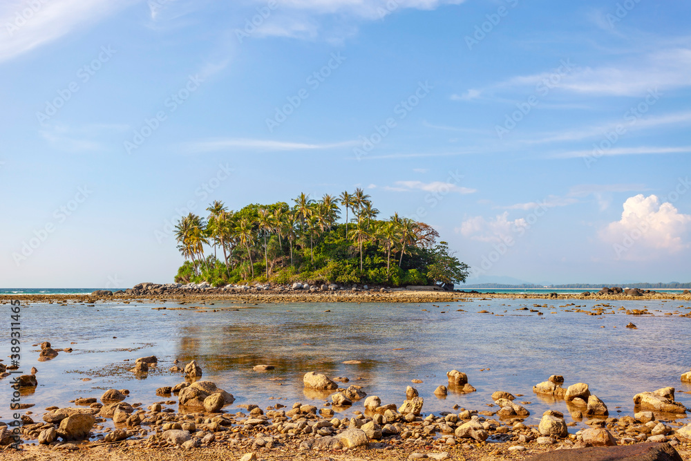 Small island in tropical sea with blue ocean and blue sky white clouds background image for nature b