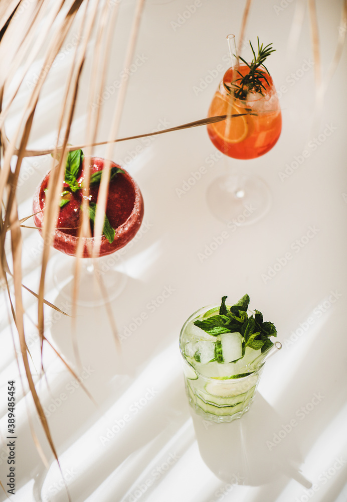Popular bar summer ice alcoholic cocktails. Gin-tonic, Aperol Spritz and strawberry basil Margarita 