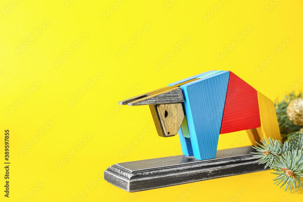 Figurine of bull and New Year decor on color background