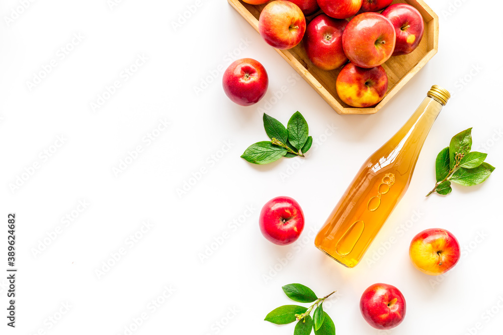 Top view of apple cider or vinegar - bottle with ripe fruits and leaves