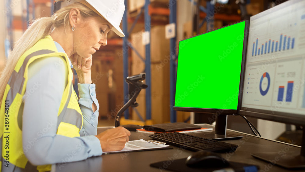Professional Female Worker Wearing Hard Hat Uses Computer with Green Chroma Screen and Inventory Del
