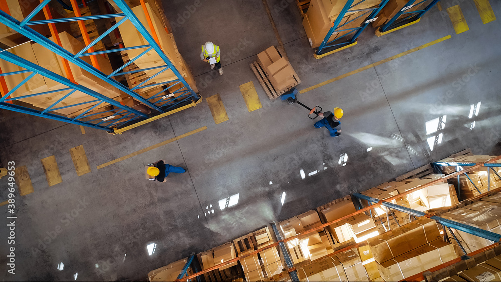 Top-Down View: In Warehouse People Working, Forklift Truck Operator Lifts Pallet with Cardboard Box.