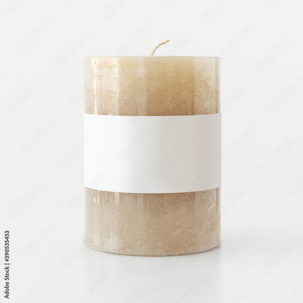 Beige pillar candle bulk on white background