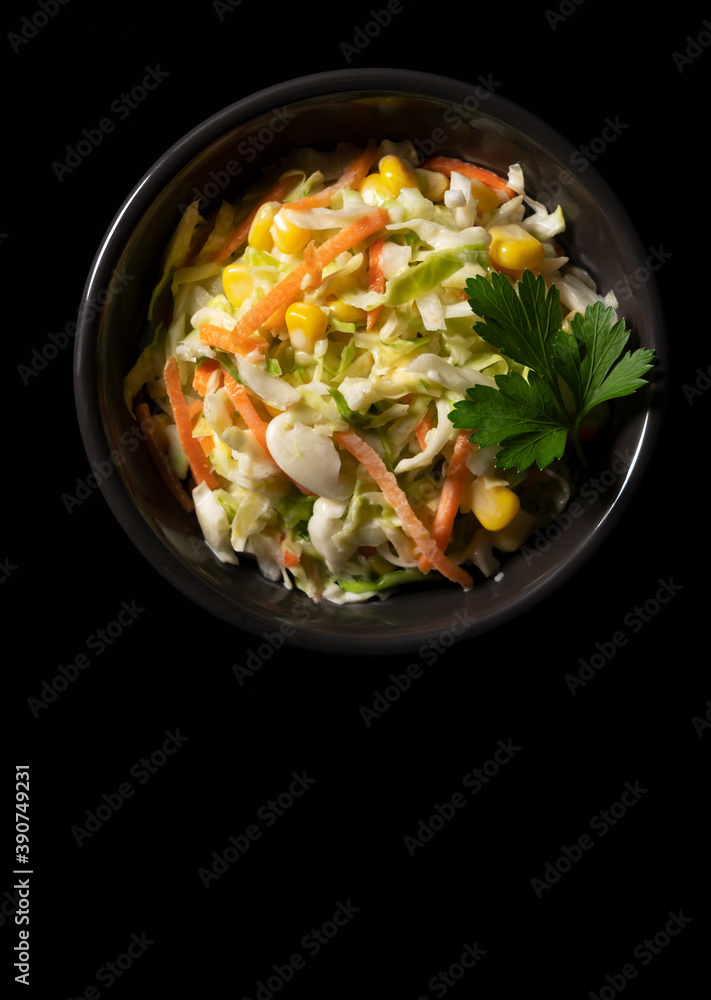Coleslaw placed on a pitch-black background