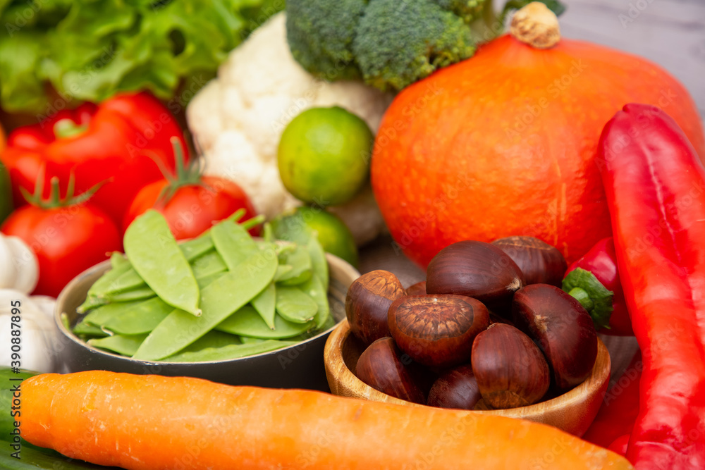 将蔬菜和水果苹果、葡萄、橙子和香蕉与胡萝卜一起放在木篮子里。