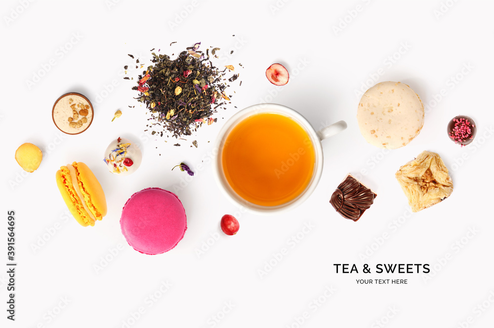 由茶、马卡龙、白底果仁糖制成的创意布局。平面布局。食物概念。