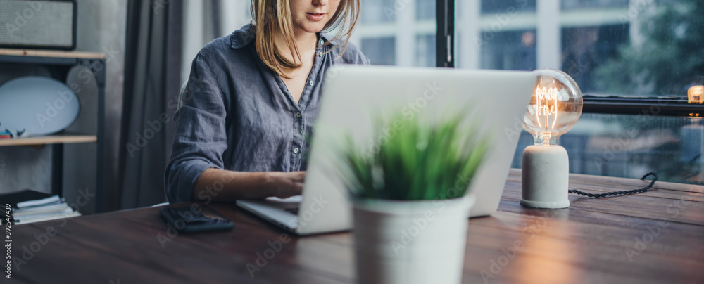 Woman working on laptop. Freelancer at remote work. Female student learning on-line via computer. Bl