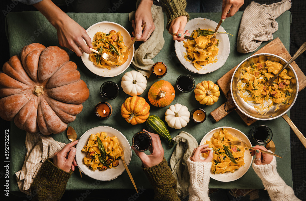 Flat-lay of Autumn dinner for gathering or Thanksgiving Day celebration. Family or friends eating bu
