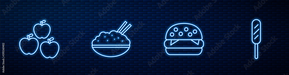 用筷子和玉米狗把汉堡、苹果、米饭放在碗里。砖墙上闪闪发光的霓虹灯图标。