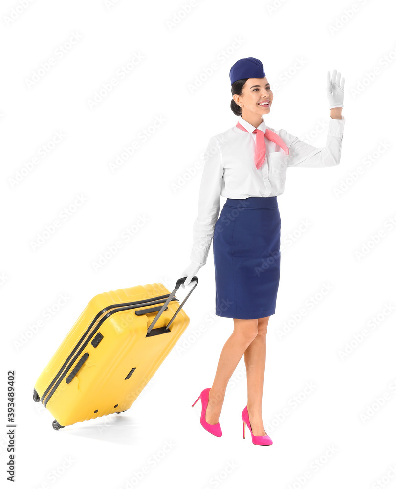 Beautiful stewardess with luggage on white background