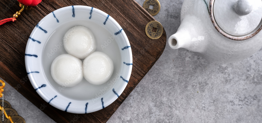 Top view of big tangyuan yuanxiao in a bowl on gray background for lunar new year food.