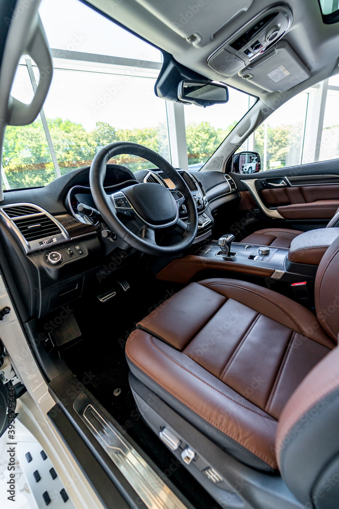 Premium car interior. Brown leather seat in luxury auto. Closeup.