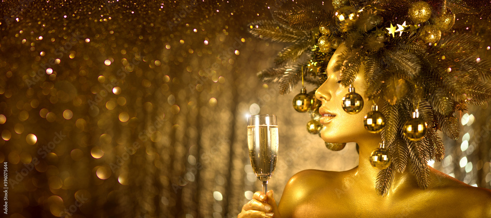 Beauty Golden Christmas Woman with champagne. Beautiful girl drinking sparkling wine, over glowing h