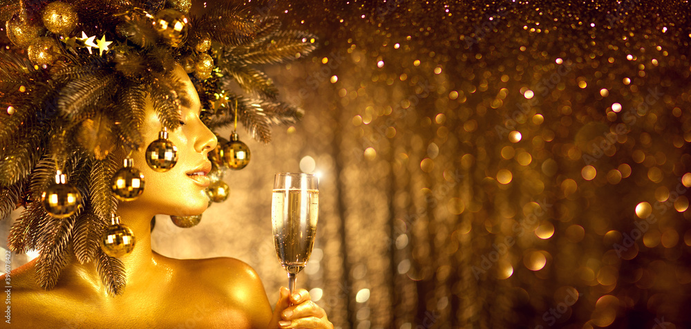 Beauty Golden Christmas Woman with champagne. Beautiful girl drinking sparkling wine, over glowing h