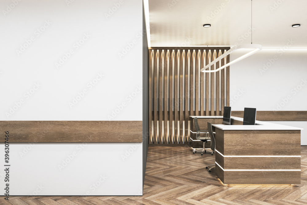 Minimalistic office lobby with blank white wall.