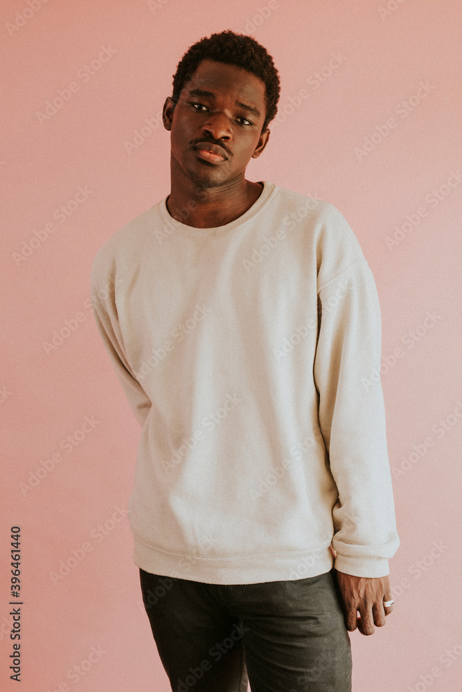 非裔美国男子穿着粉色背景的白色毛衣模型