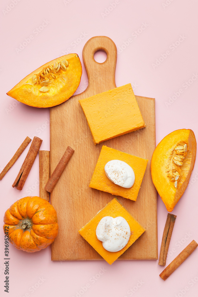 Board with pieces of tasty pumpkin pie on color background