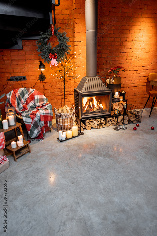 Fireplace area of a beautiful loft-style interior with real brick and concrete floors decorated for 