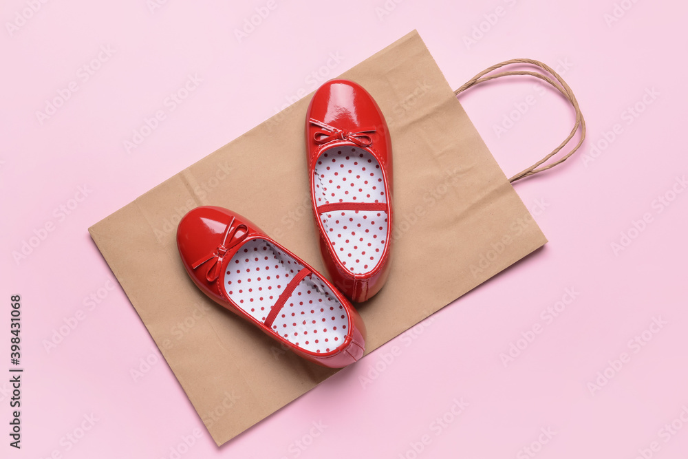 Little girl shoes on color background