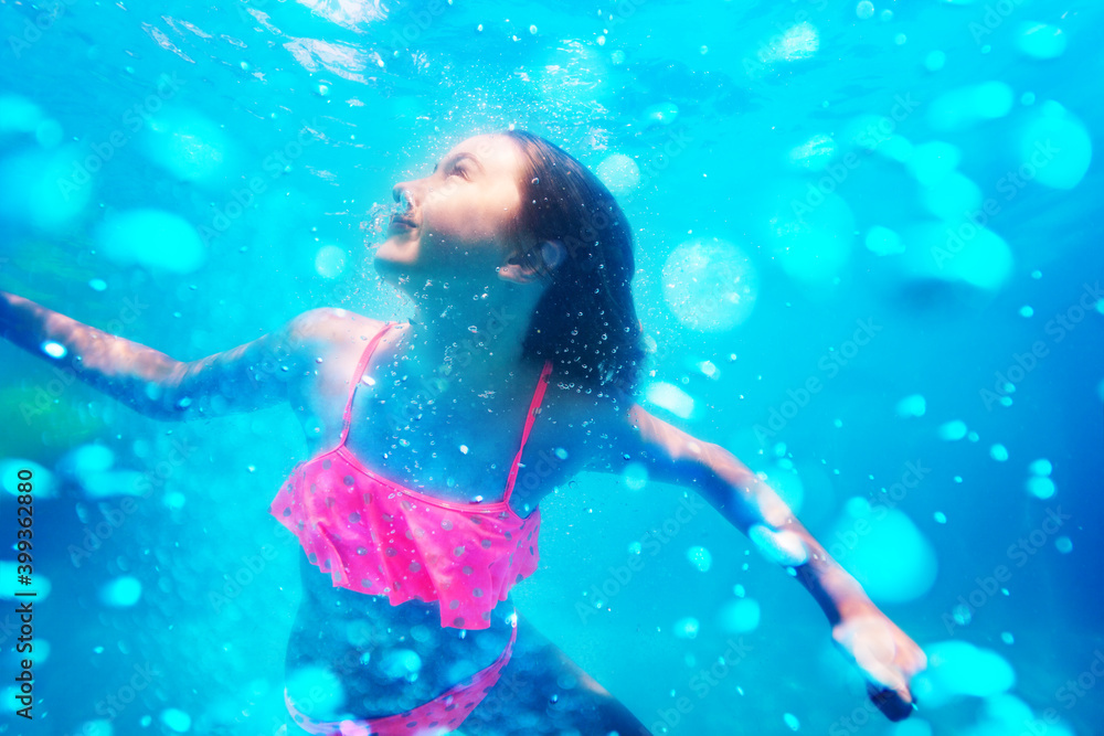 女孩在水池中潜水，水中有气泡的肖像