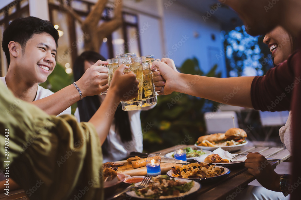 Group holiday party of asian people Eating dinner and drinking beer at home