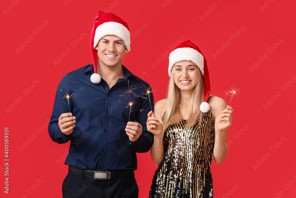 幸福的年轻情侣，彩色背景上有圣诞亮片