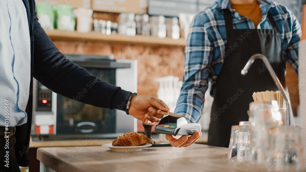 非裔美国客户在Smar上使用非接触式NFC支付技术支付咖啡和糕点