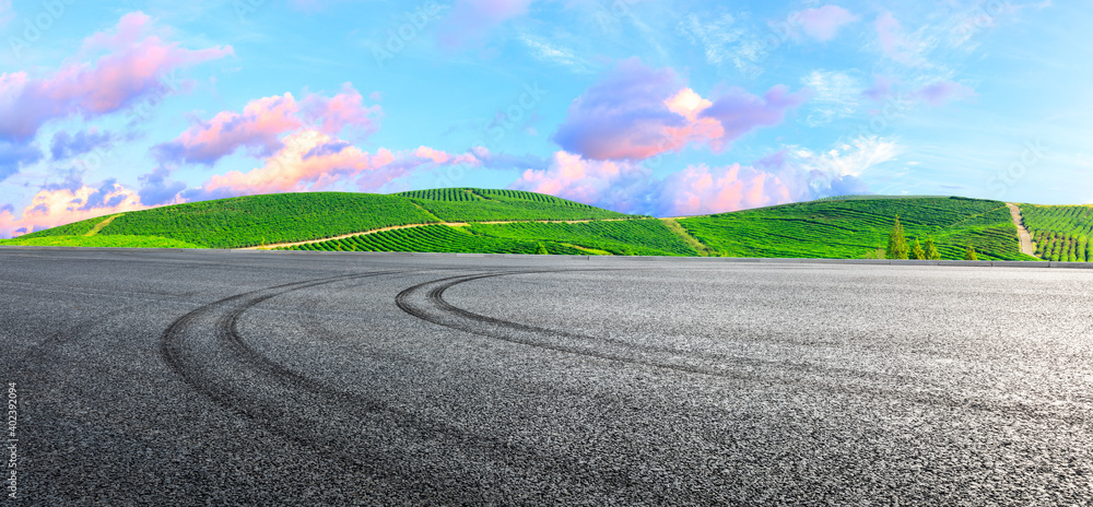 Asphalt road ground and mountain at sunset.Race track road and mountain background.