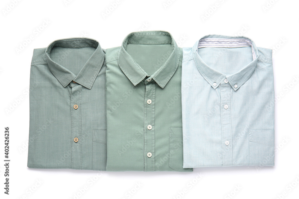 Folded male shirts on white background