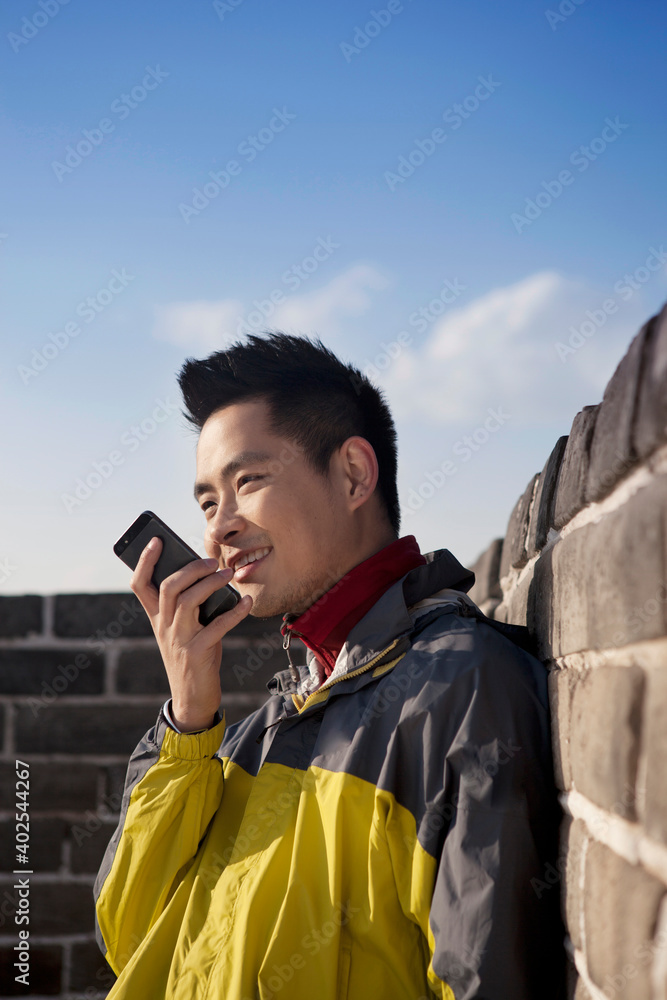 一个年轻人在长城旅游中使用对讲机
