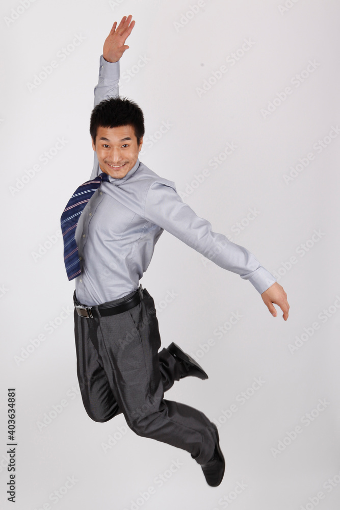 A business man jumping up in a shirt