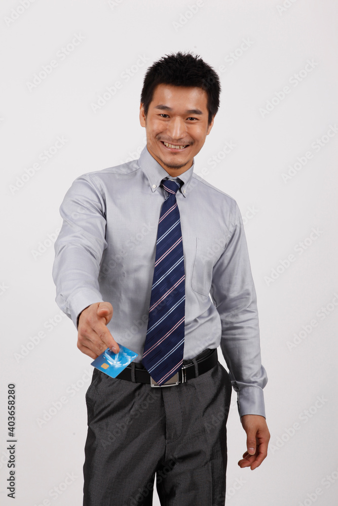 A young business man with a bank card
