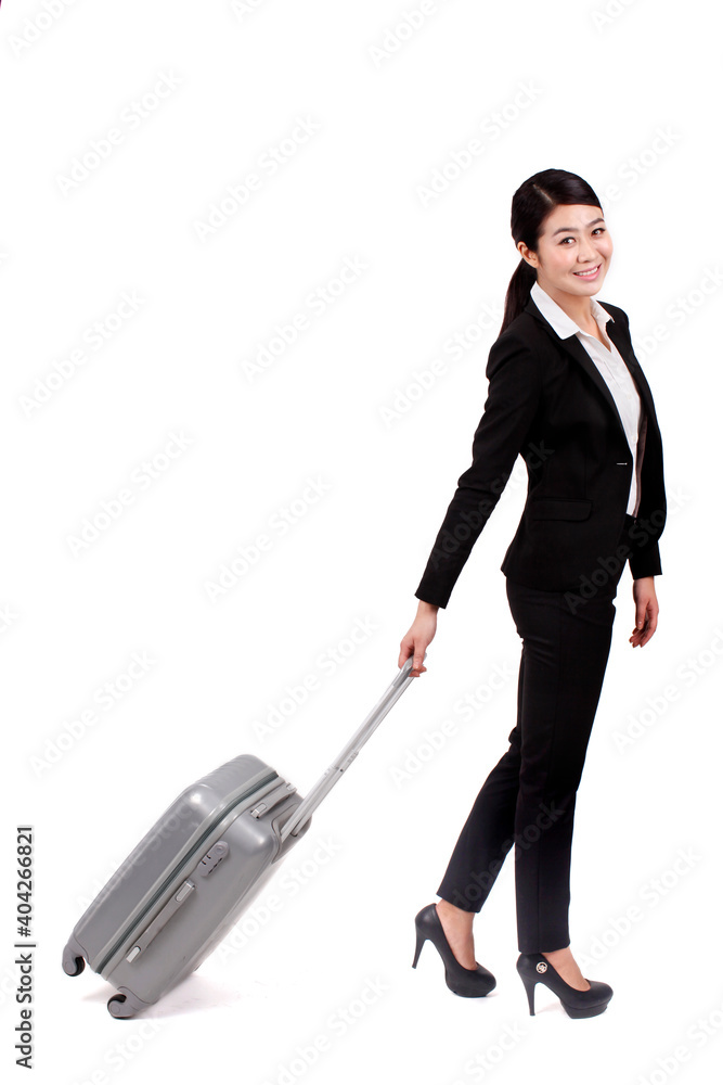 A young Business woman pulling a suitcase 