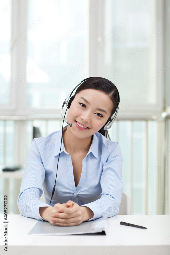 Young Female office worker wearing headset portrait