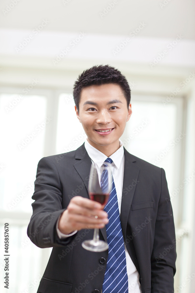 商人拿着一杯葡萄酒的画像