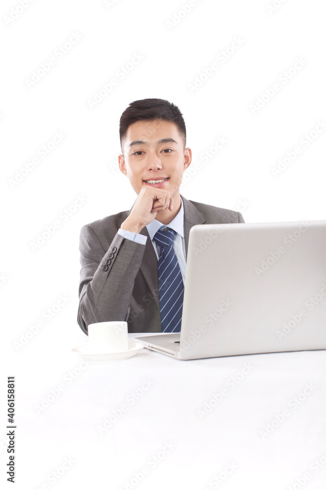 Portrait of young bisinessman sitting in the front of laptop 