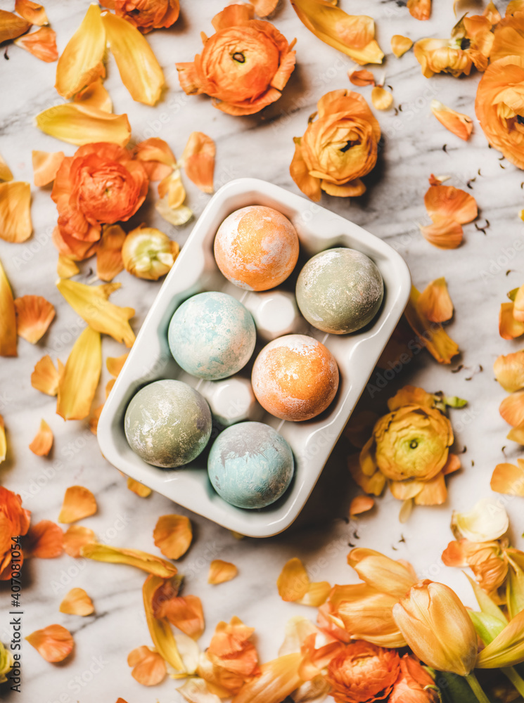 Easter holiday background, texture and wallpaper. Flat-lay of colorful dyed Easter eggs in white cer
