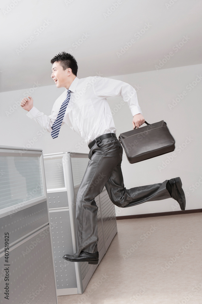 Portrait of Businessman running with briefcase,side view