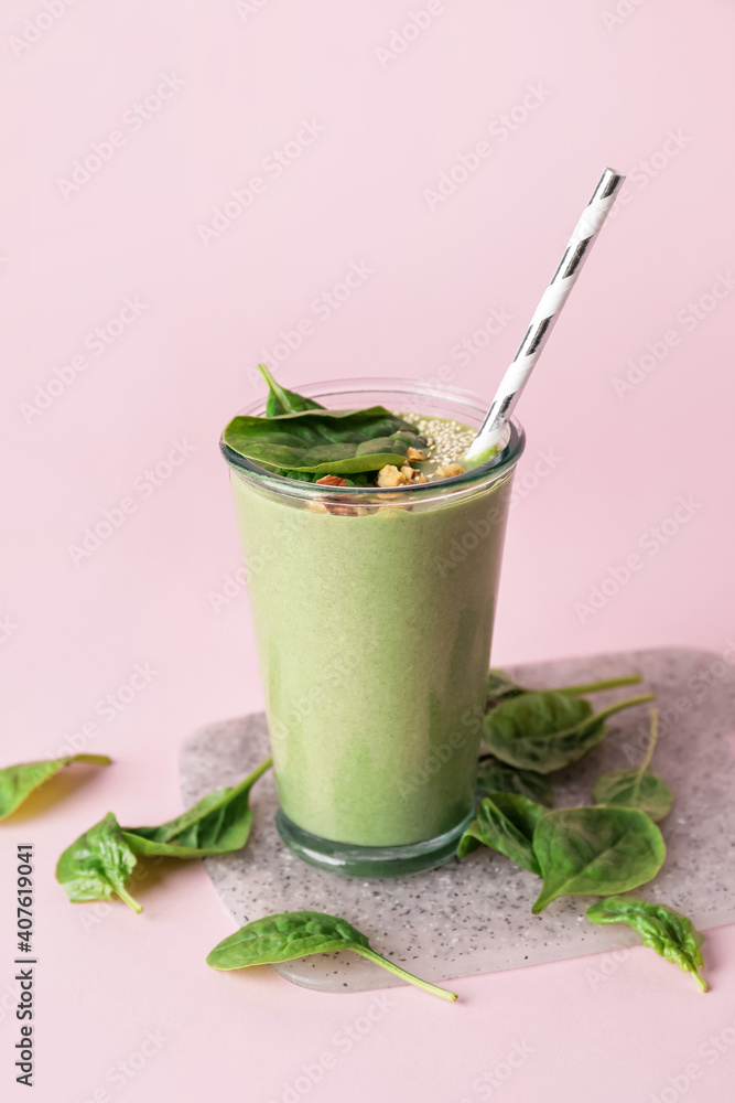 Glass of healthy spinach smoothie on color background