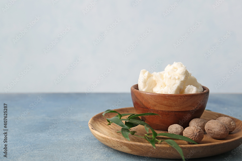 Bowl with shea butter on table