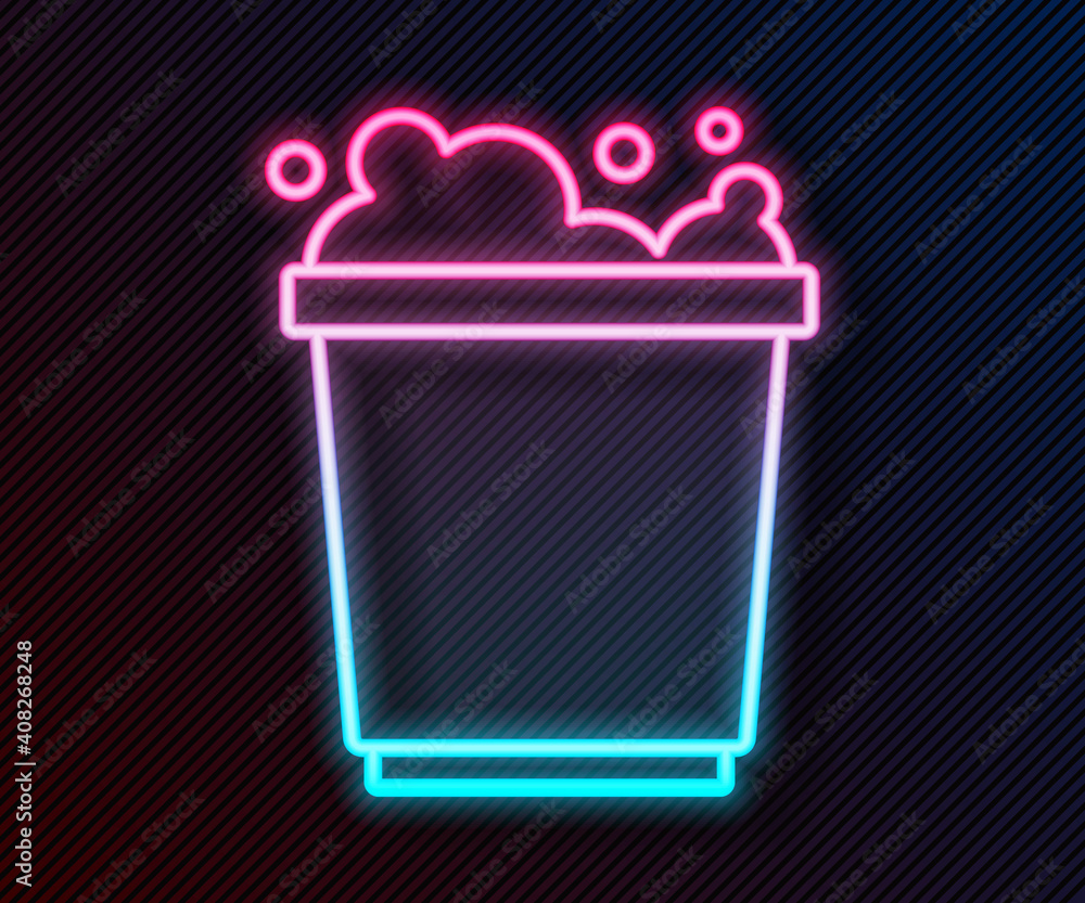 Glowing neon line Bucket with foam and bubbles icon isolated on black background. Cleaning service c
