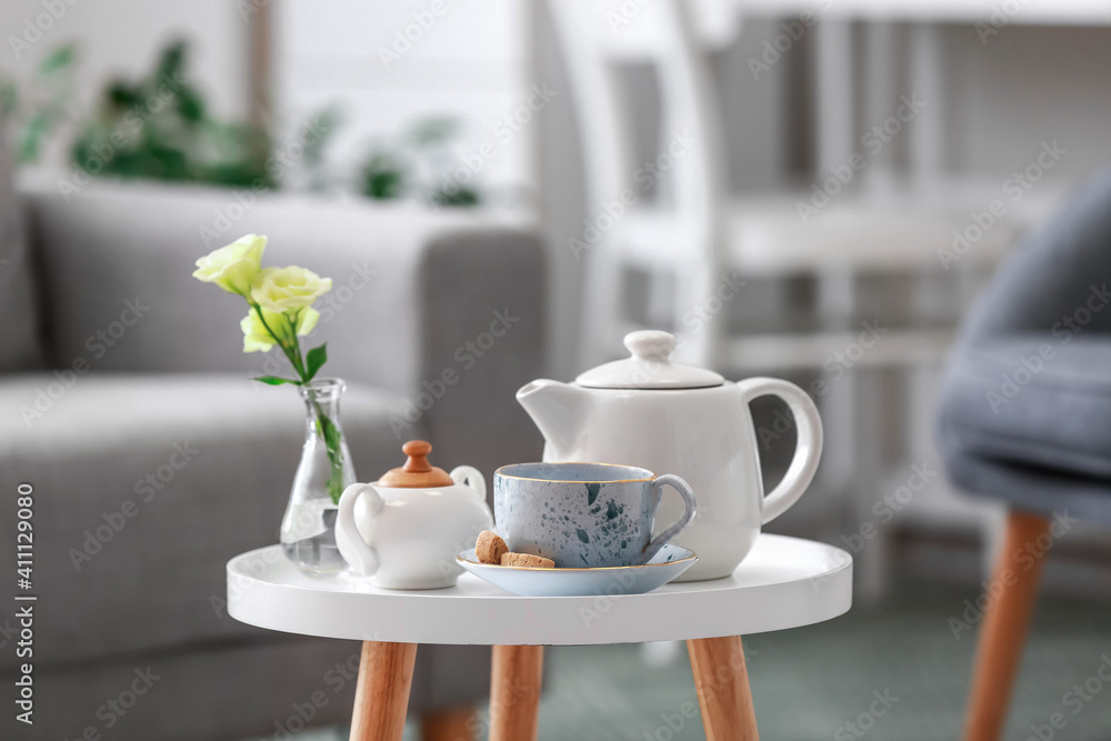 Teapot and cup on table in room