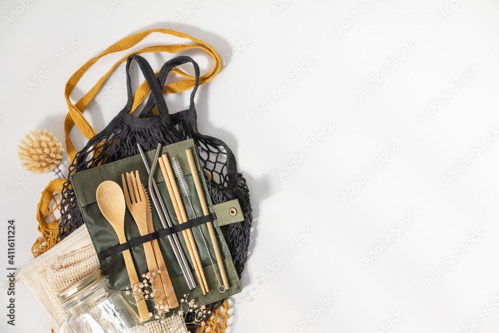 Set of Eco friendly bamboo cutlery and mesh bags on white background