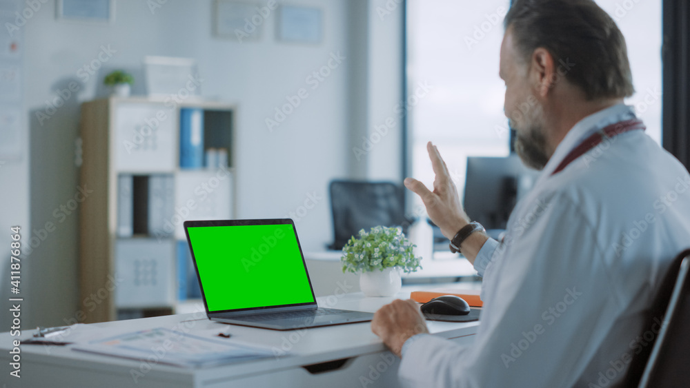 Family Medical Doctor is Making a Video Call with Patient on a Computer with Green Screen Display in