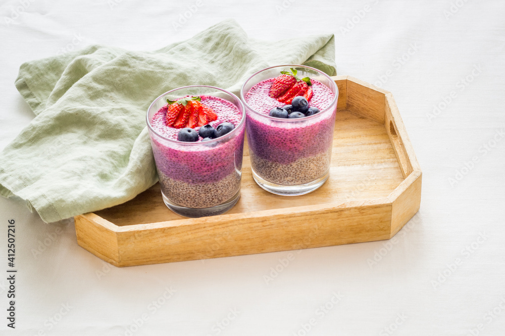 Homemade yogurt chia seeds pudding with strawberries in glasses